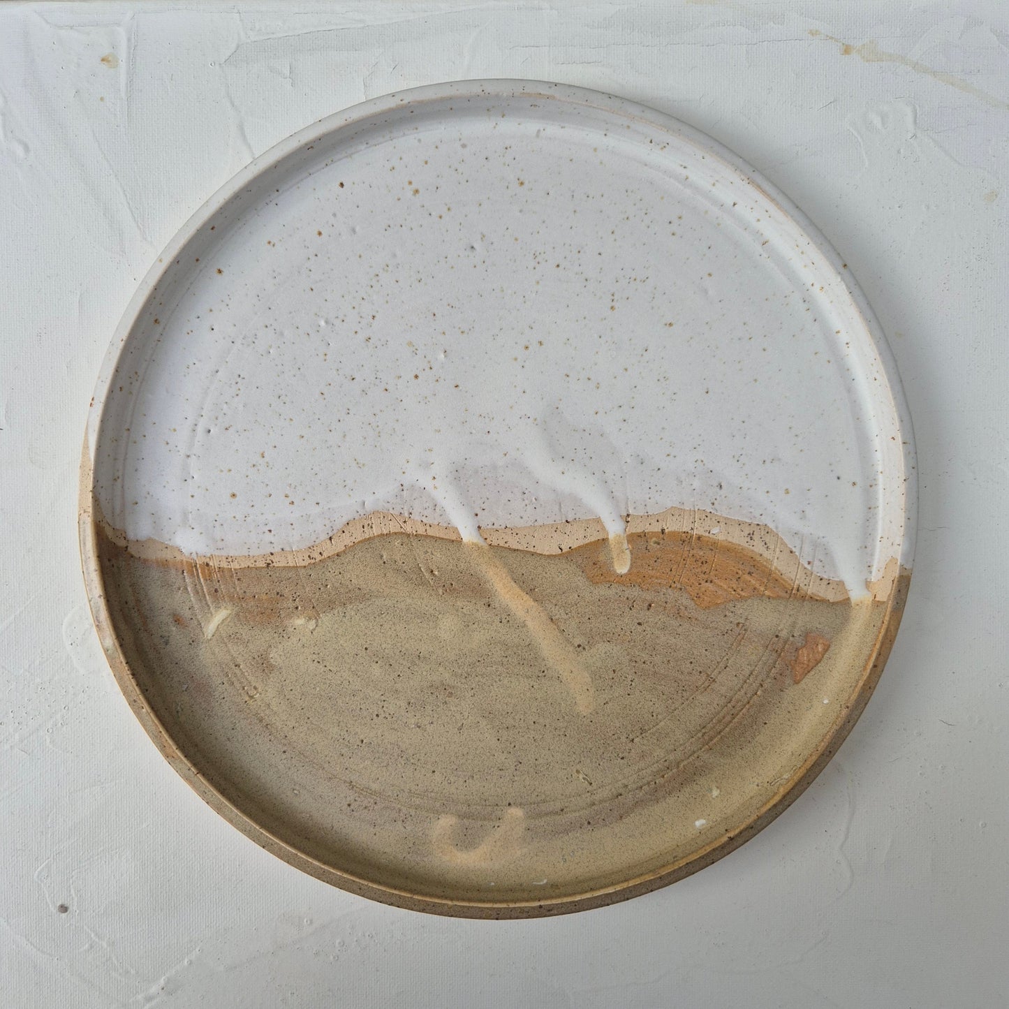 Ceramic plate with a "crack" on a white background