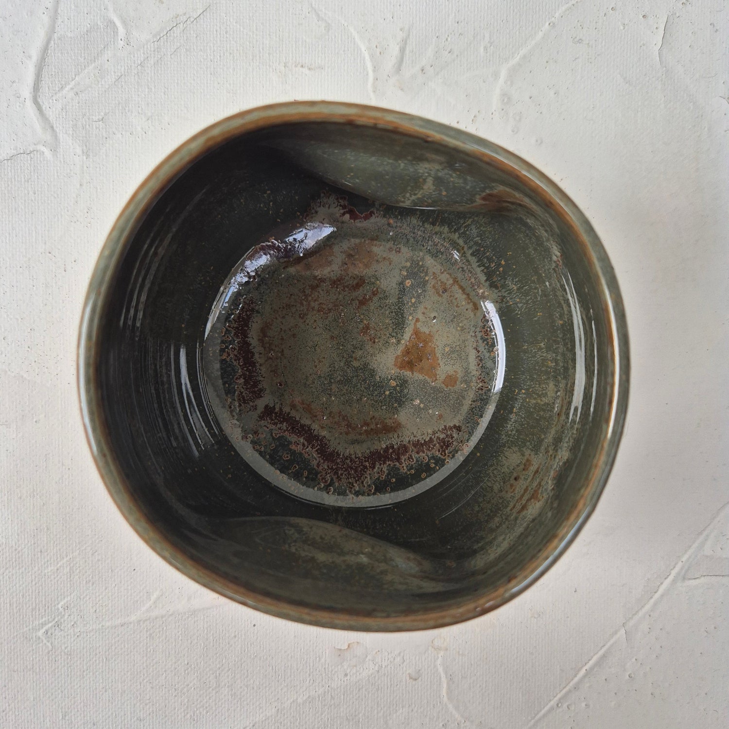 Ceramic bowl with a textured surface on a light gray background