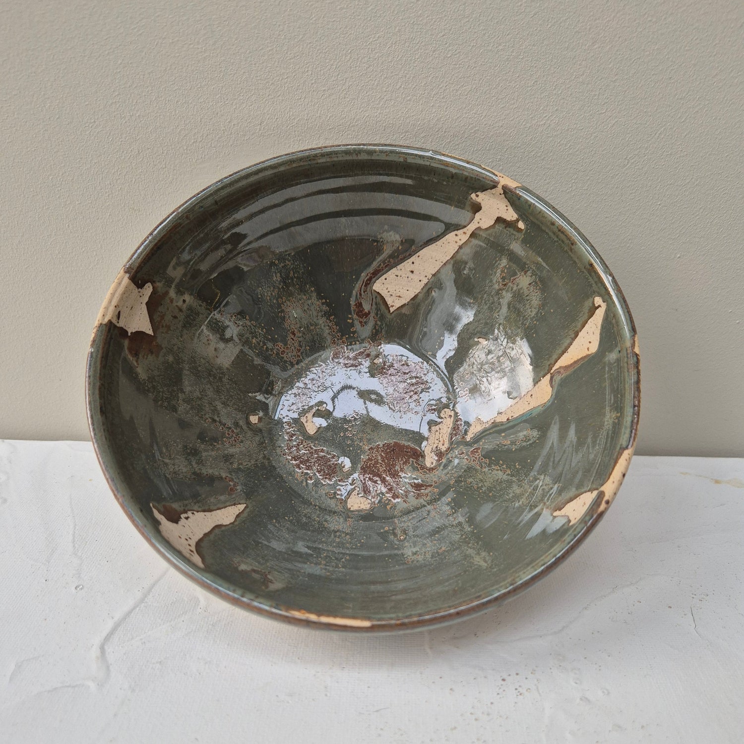 Ceramic bowl with a textured surface on a light gray background
