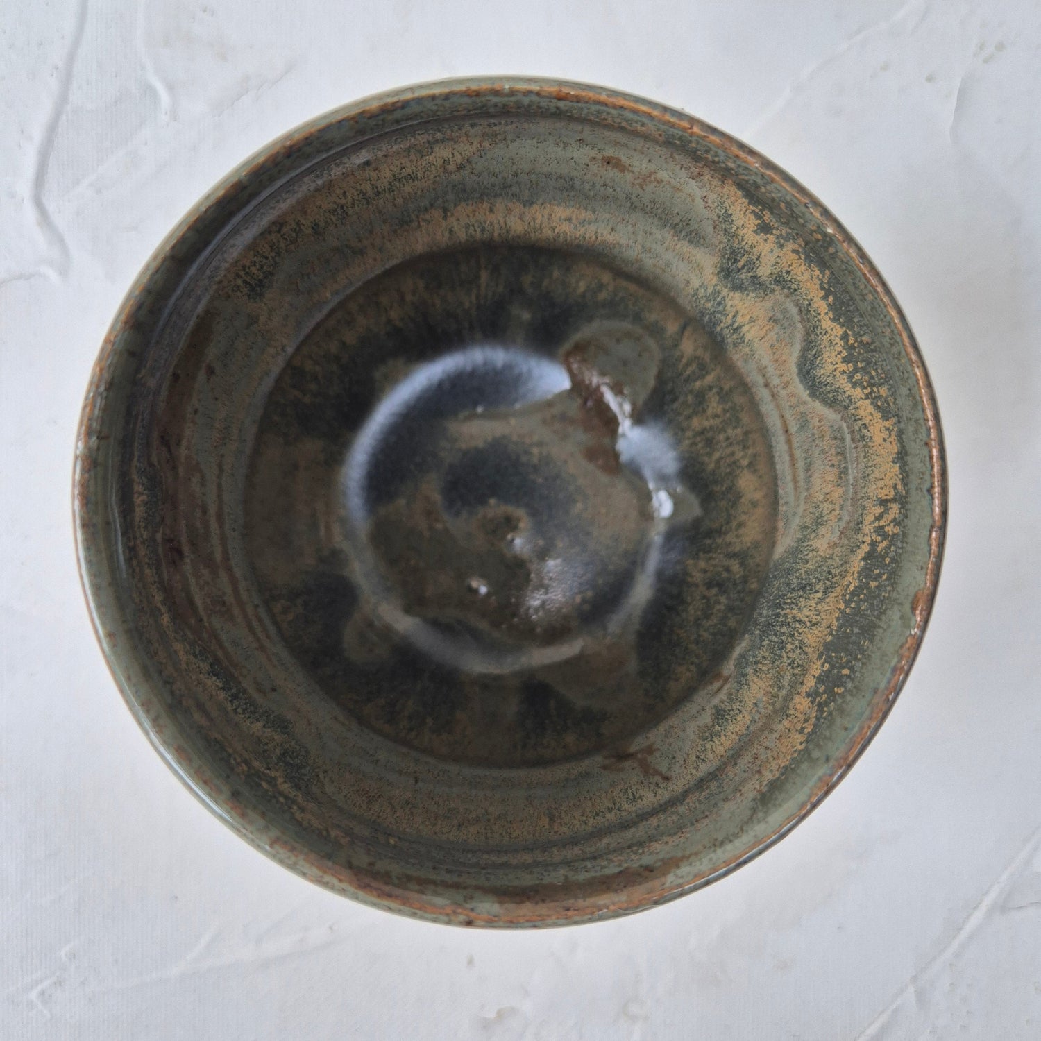 Ceramic bowl with a textured surface on a light gray background