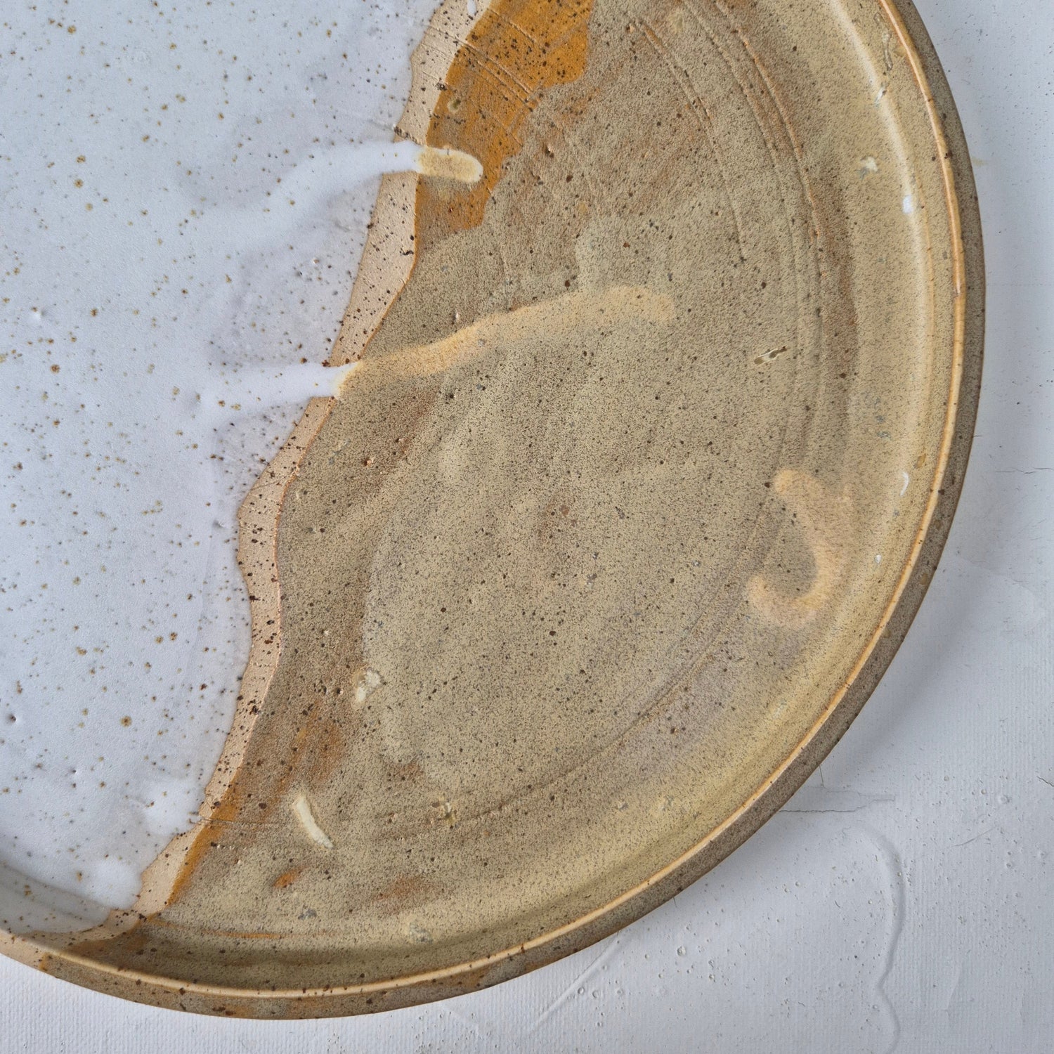 Ceramic plate with a textured surface on a white background