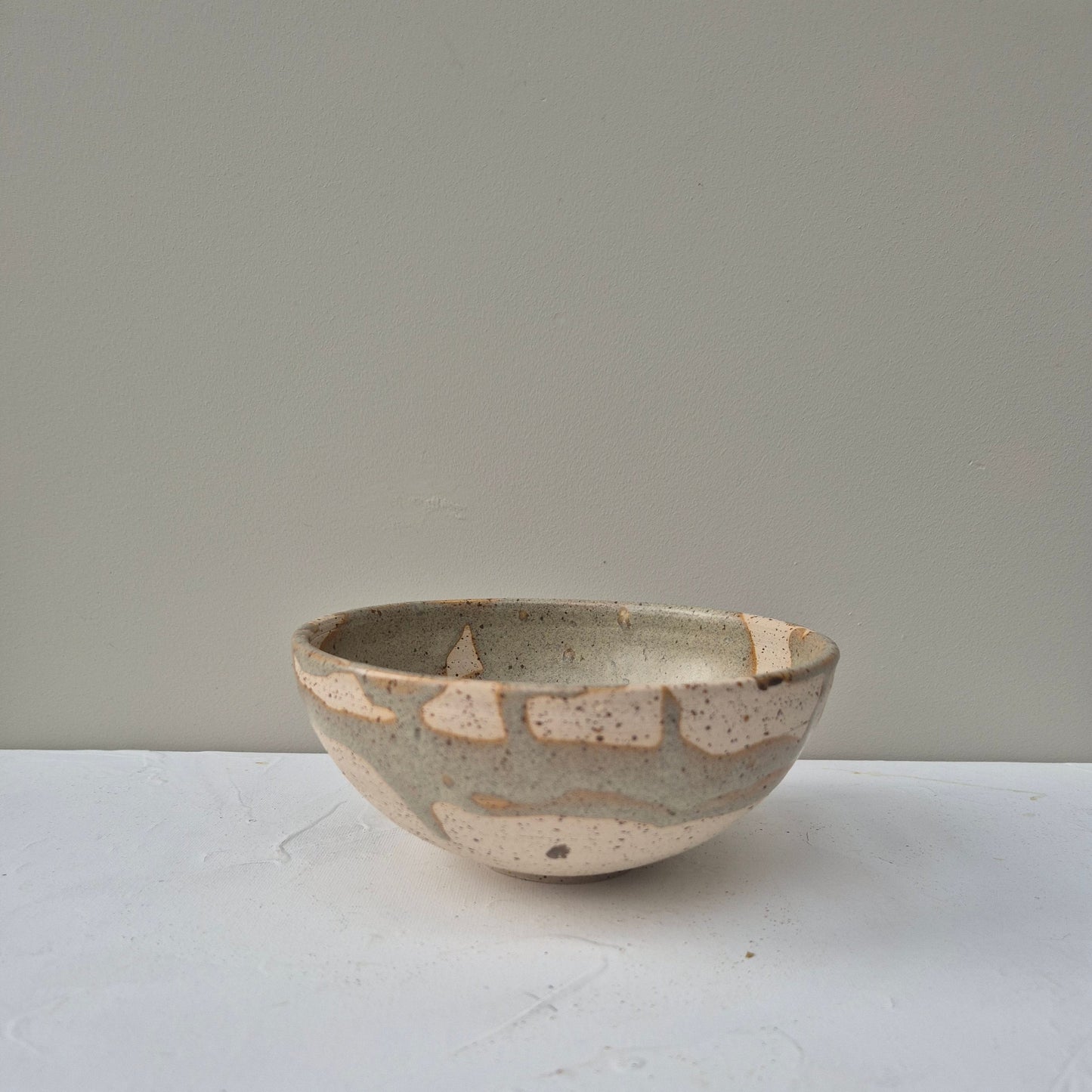 Ceramic bowl with a textured surface on a plain background