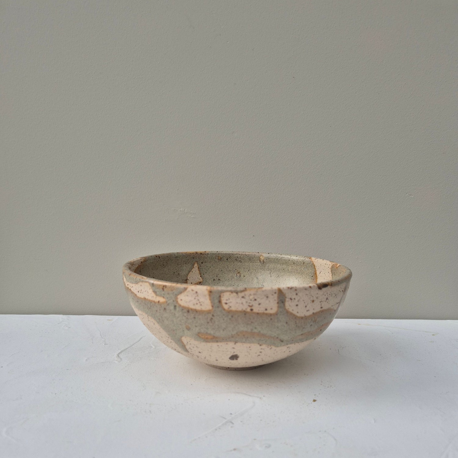 Ceramic bowl with a textured surface on a plain background