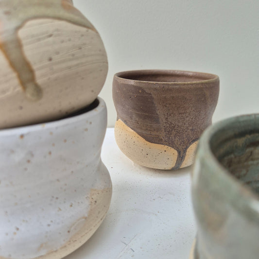 Close-up of ceramic cups on a light gray background
