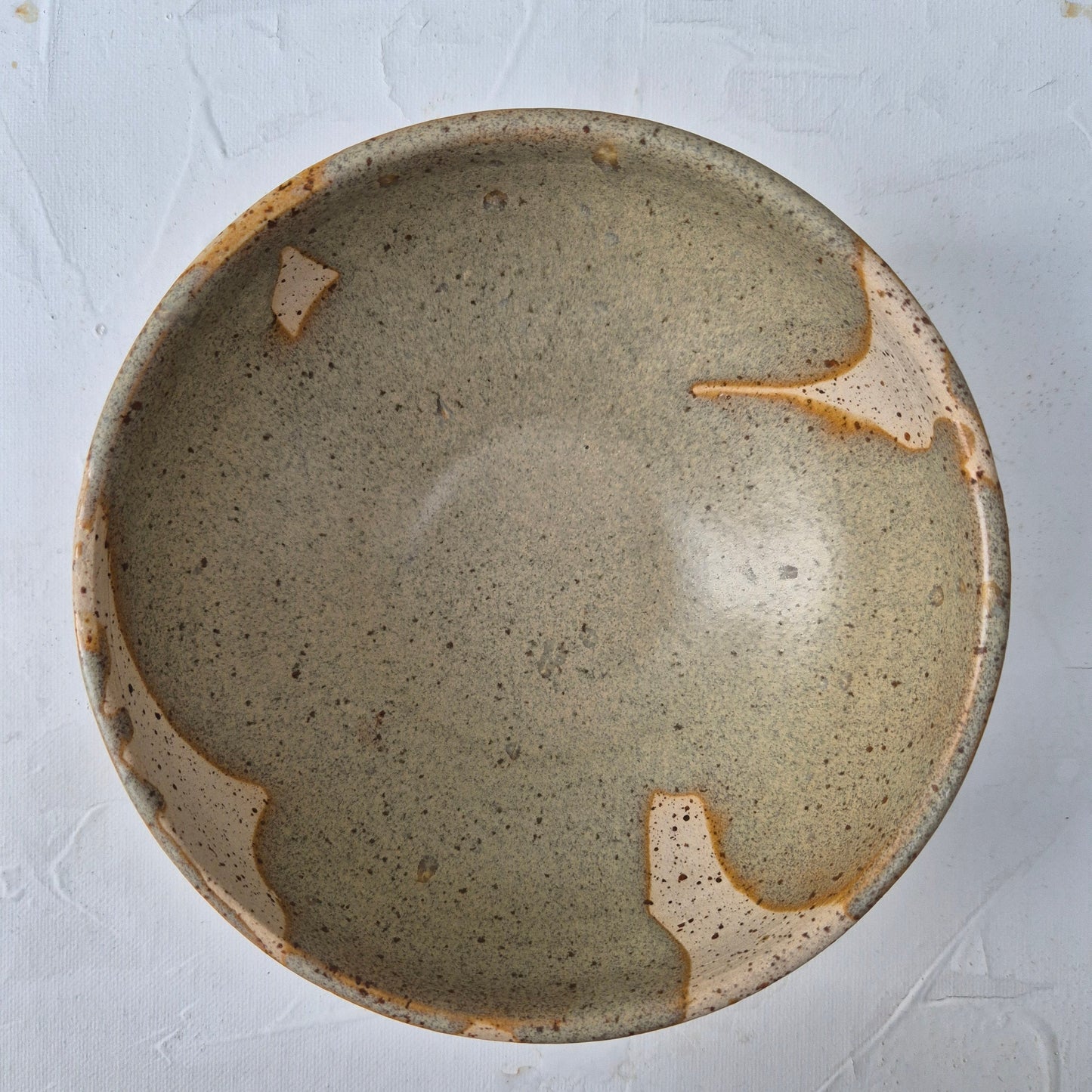 Ceramic bowl with a textured surface on a light gray background