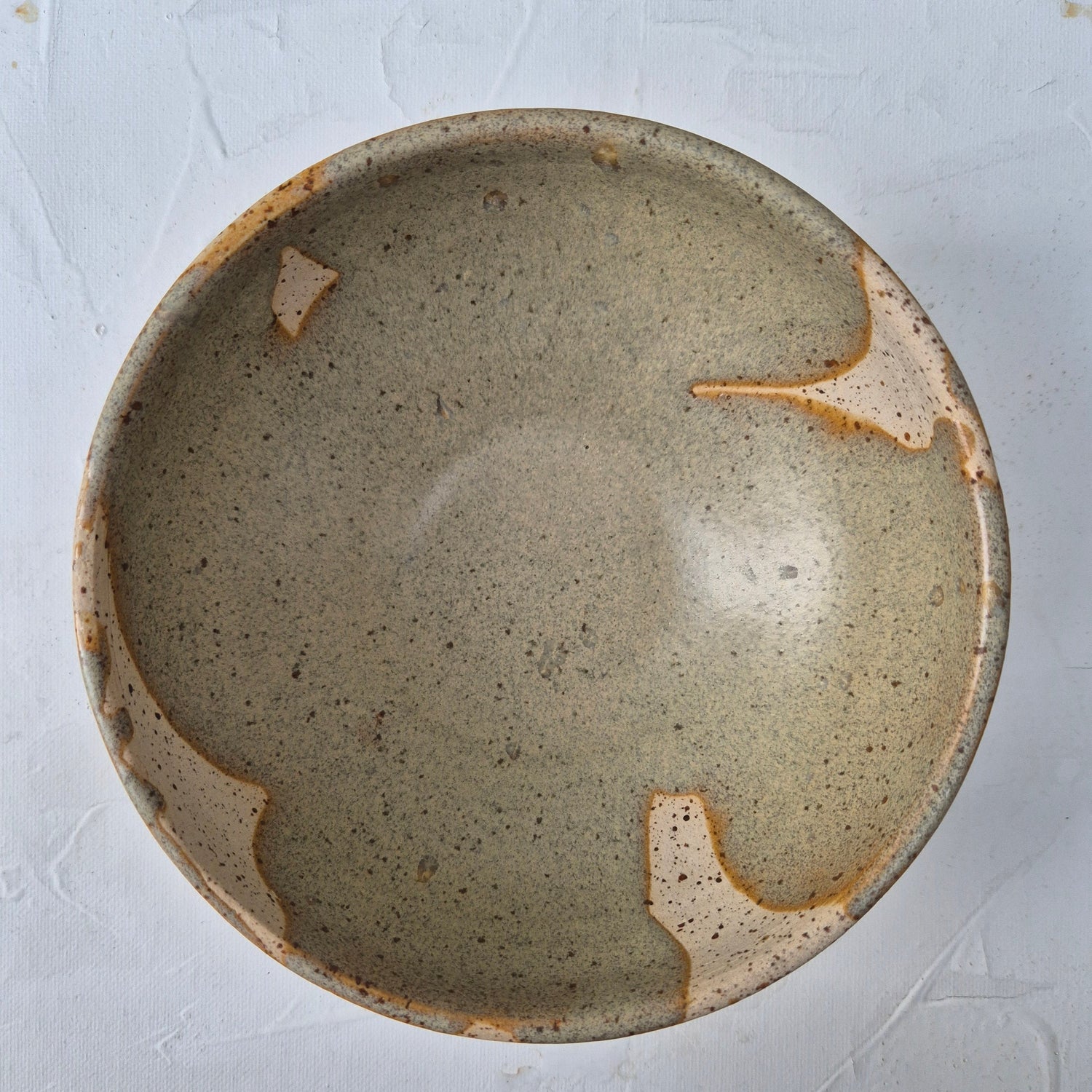 Ceramic bowl with a textured surface on a light gray background
