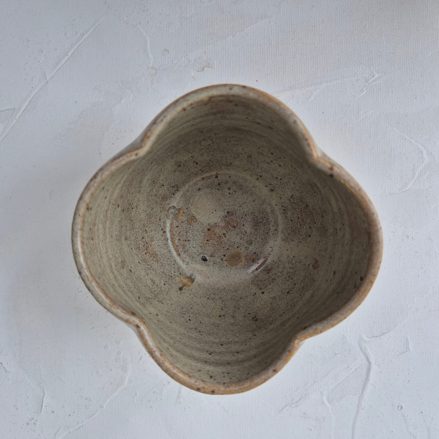 Ceramic bowl with a textured surface on a light gray background