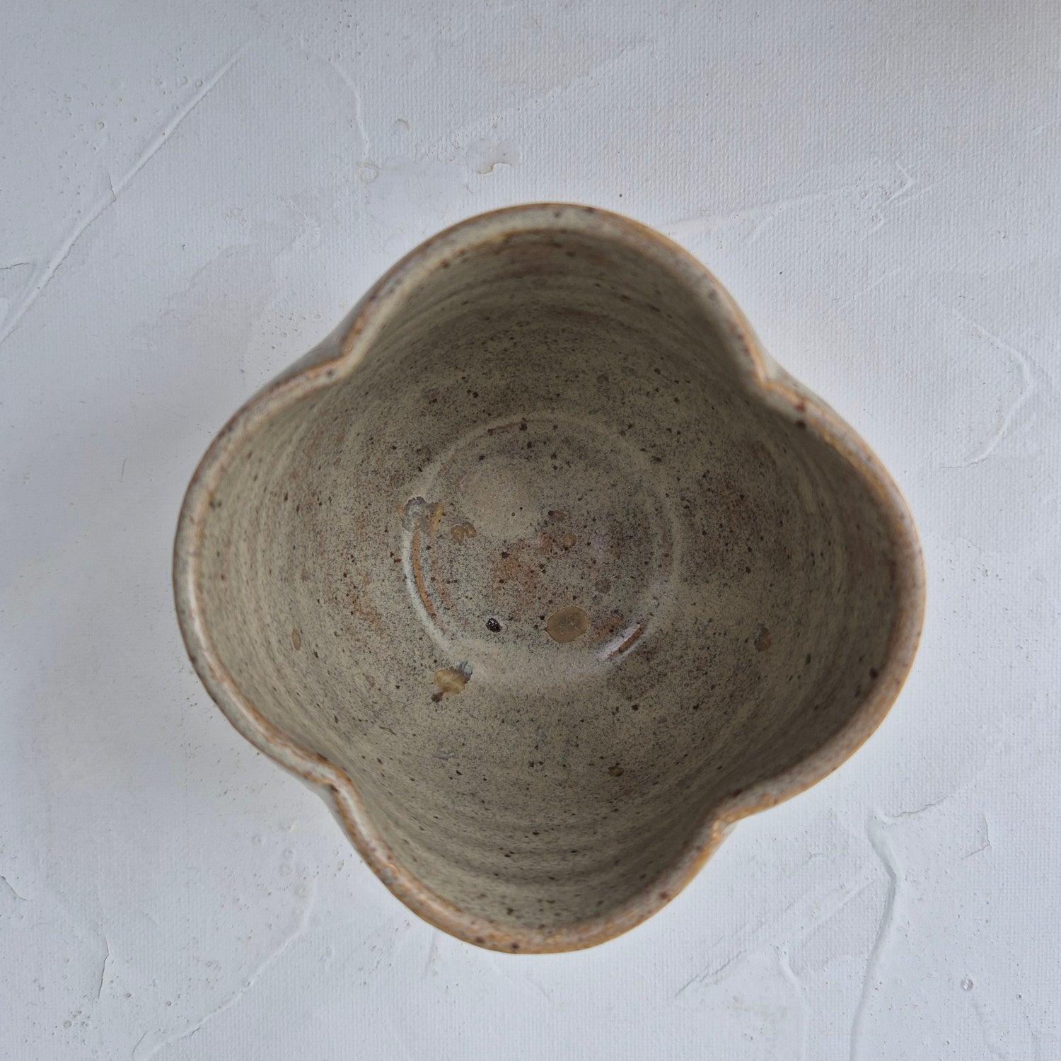 Ceramic bowl with a textured surface on a light gray background