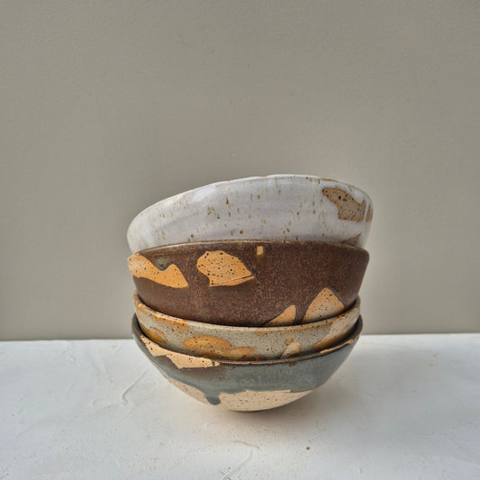 stuck of different colour ceramic bowls