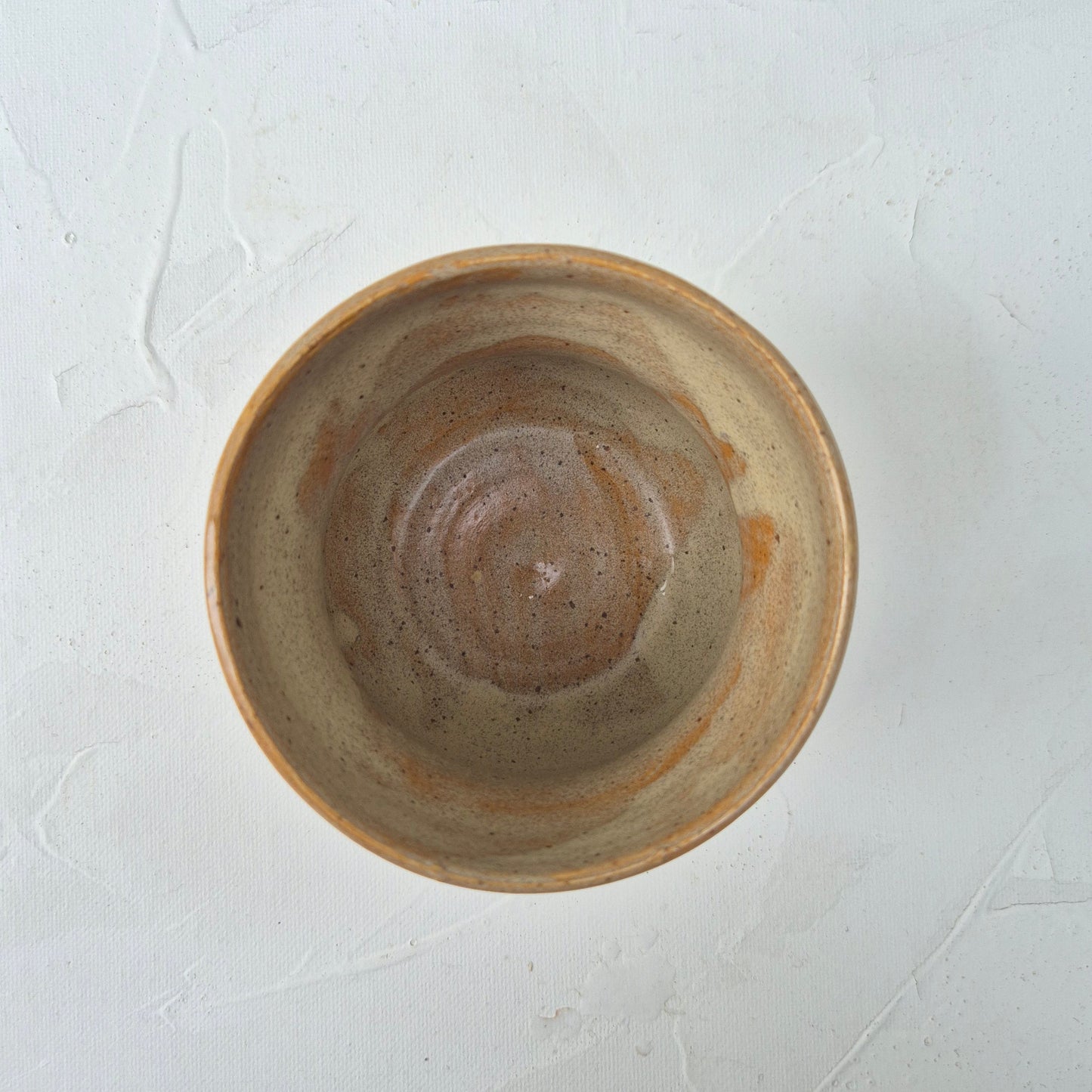 Ceramic bowl with a brown glaze on a white background